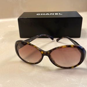 CHANEL tortoise sunglasses with black crystal detail.